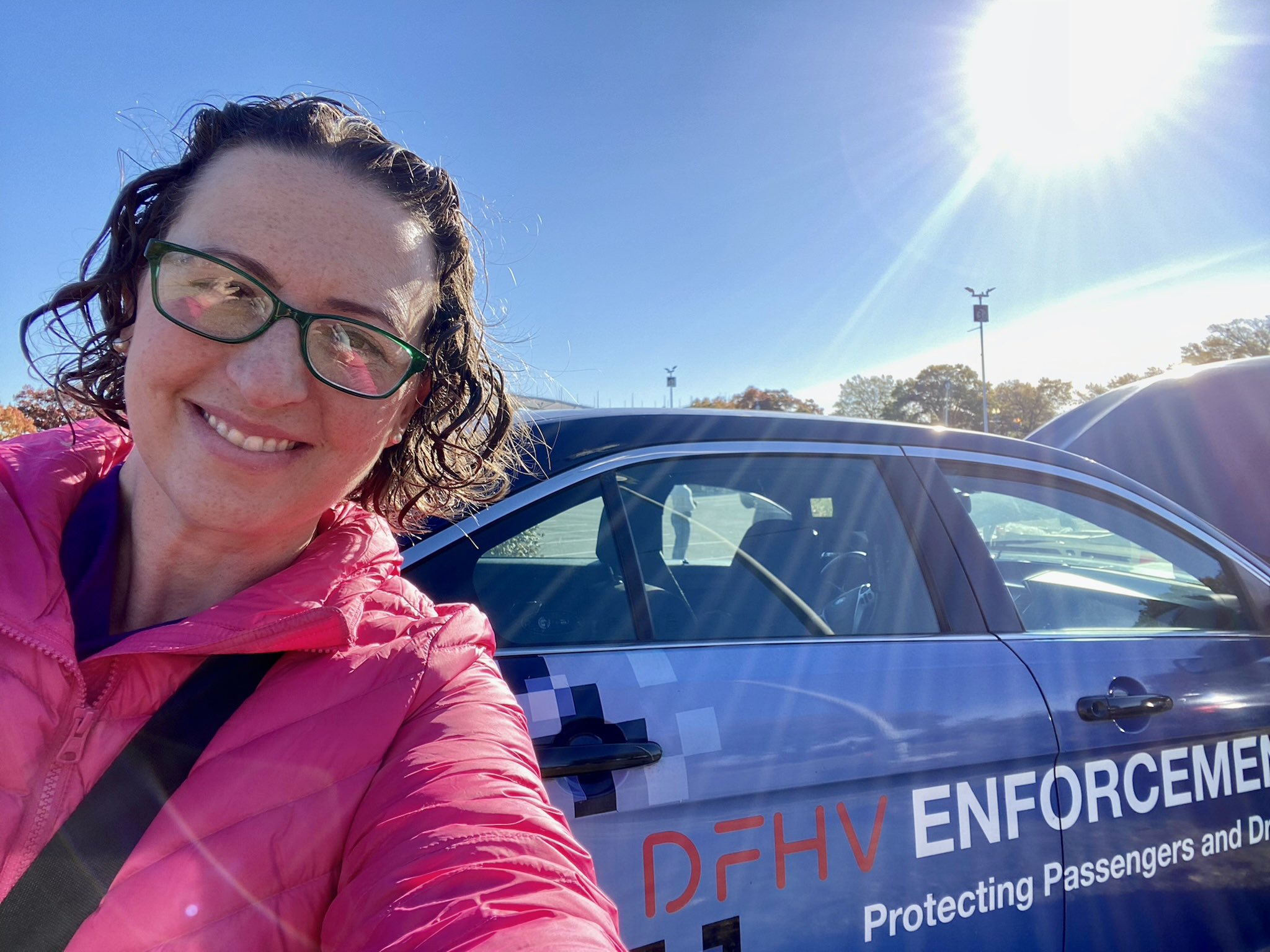 Councilmember Nadeau takes a selfie in front of a Department of For Hire Vehicles enforcement vehicle.