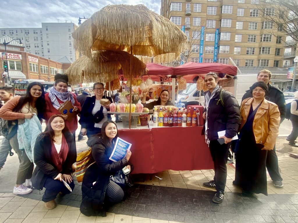 Councilmember Nadeau poses with street vendors.