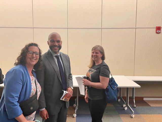 Councilmembers Brianne K Nadeau and Robert White pose for a photo with a community member at ANC 1D meeting