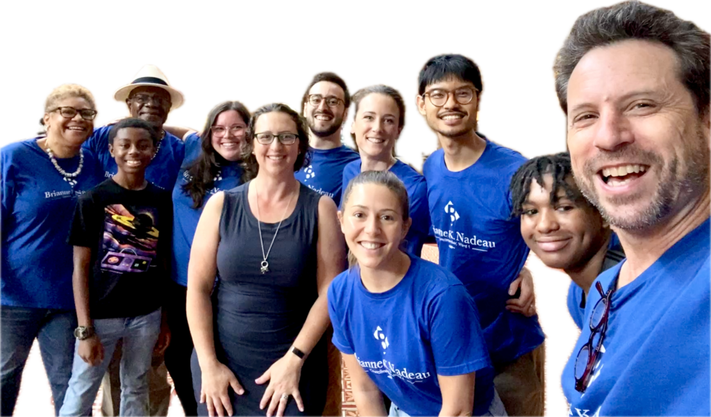 Nadea staff selfie with nine peope, most wearing blue Brianne Nadea t-shirts.