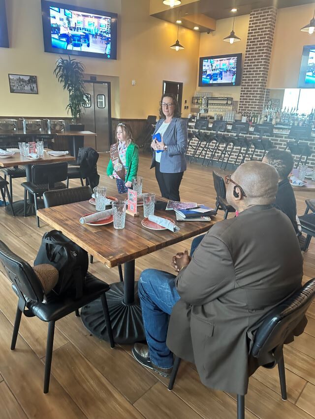 Councilmember Brianne K Nadeau, with her daughter Zoe, speaks to Ward 7 Faith Leaders