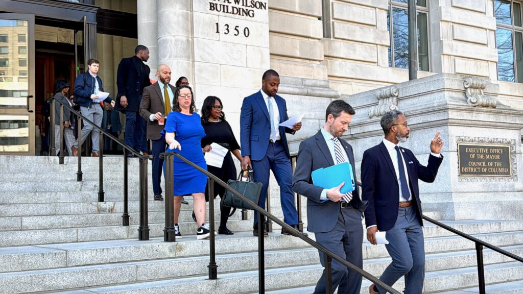 Councilmembers walking down steps of Wilson building