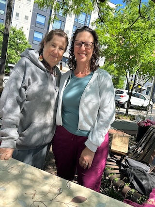 Councilmember Nadeau poses for a photo with a woman at the farmer's market