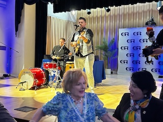 A band plays on stage at the graduation ceremony