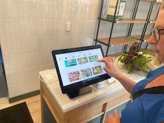 Councilmember Nadeau places an order at a self-service kiosk.