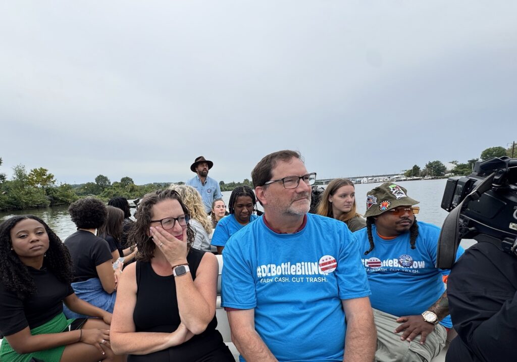 Councilmember Brianne Nadeau and others wearing blue #DCBottleBillNow t-shirts on a boat tour of the Anacostia