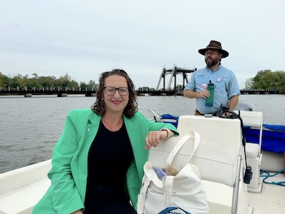 Councilmember Brianne K Nadeau on a boat on the Anacostia River with Trey Sherard, the Anacostia Riverkeeper