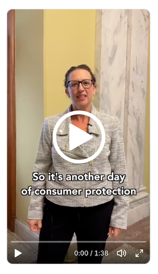 Video still of Council Brianne K Nadeau speaking in hallway of John A Wilson Building. Caption reads "So it's another day of consumer protection". White play button over image.