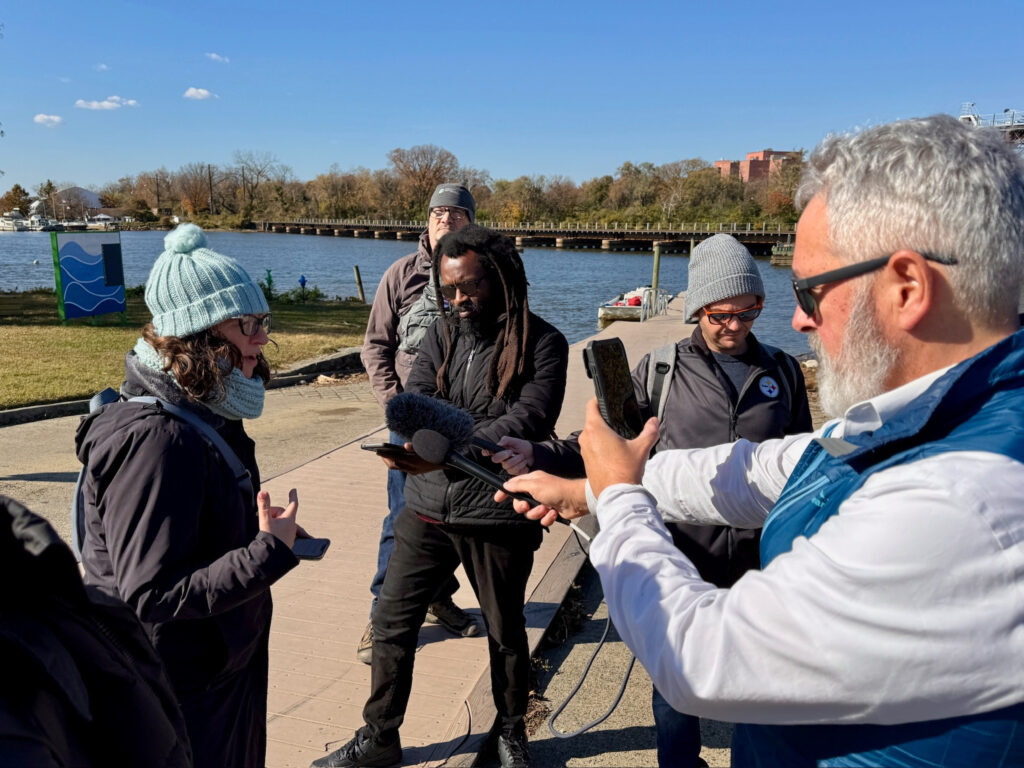 Councilmember Brianne K Nadeau speaks with members of the press on the banks of the Anacostia