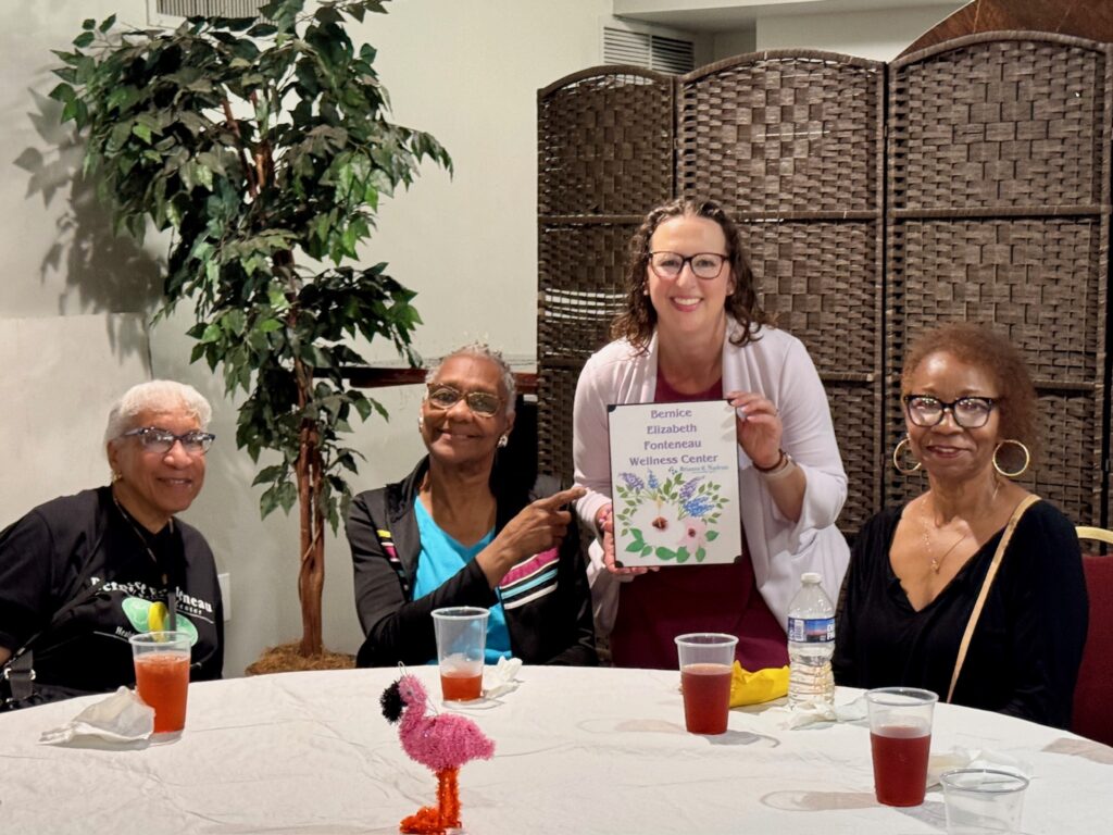 Councilmember Nadeau visits at a table with three women at the annual senior dance