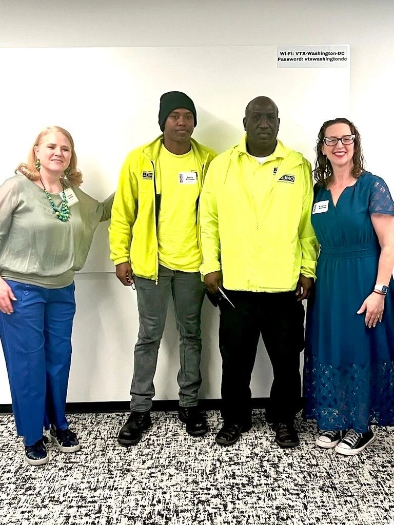Councilmember Nadeau, Kristen Barden from the Adams Morgan BID, and two men from the Safety Team, wearing yellow shirts and jackets, pose for a photo.
