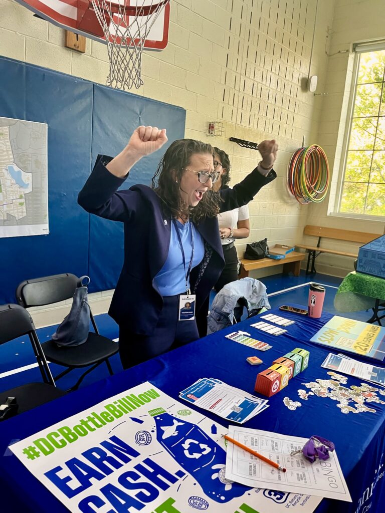 Brianne K Nadeau cheering with her hands in the air at Cleveland Elementary School career day fair