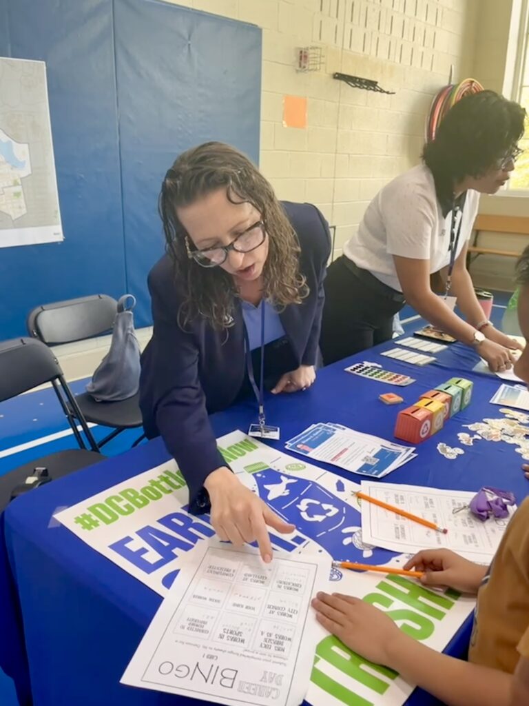 Brianne K Nadeau cheering with her hands in the air at Cleveland Elementary School career day fair
