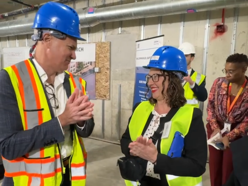 Councilmember Nadeau and a Jubilee Housing official speak with each other, both wearing hard hats