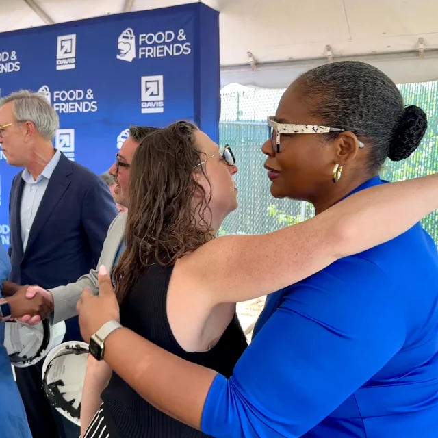 Councilmember Nadeau gives a warm embrace to another participant in the event
