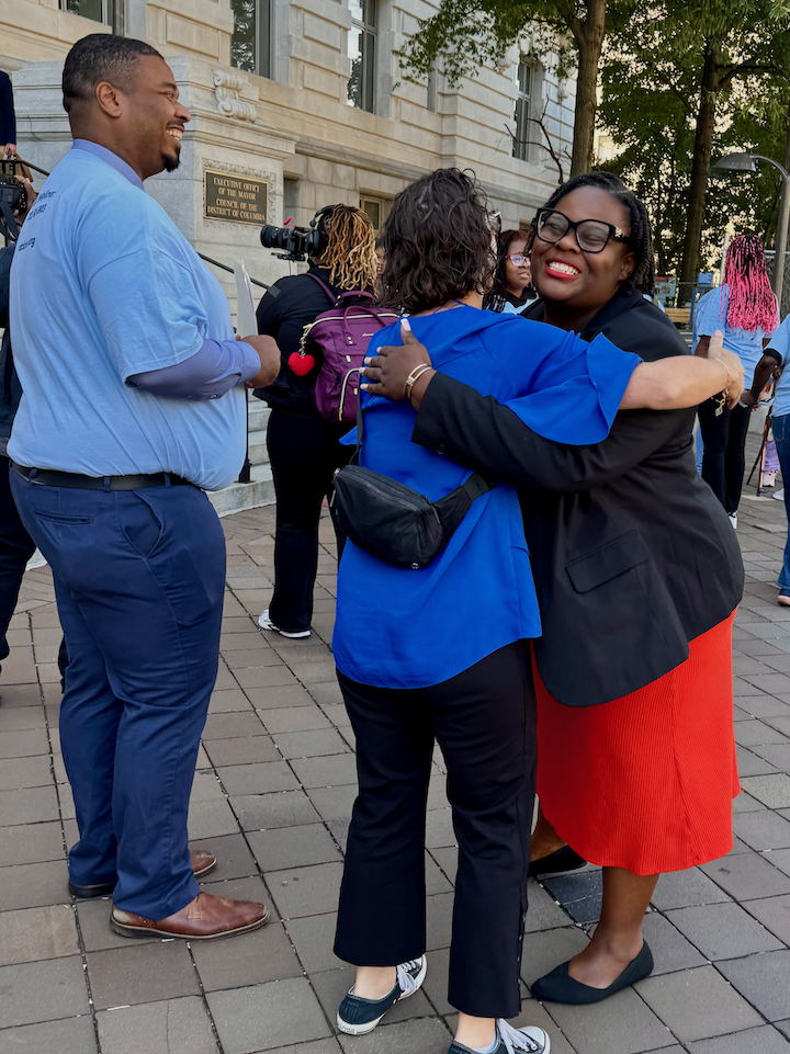Councilmember Nadeau hugs a woman at the DC Kincare Alliance rally