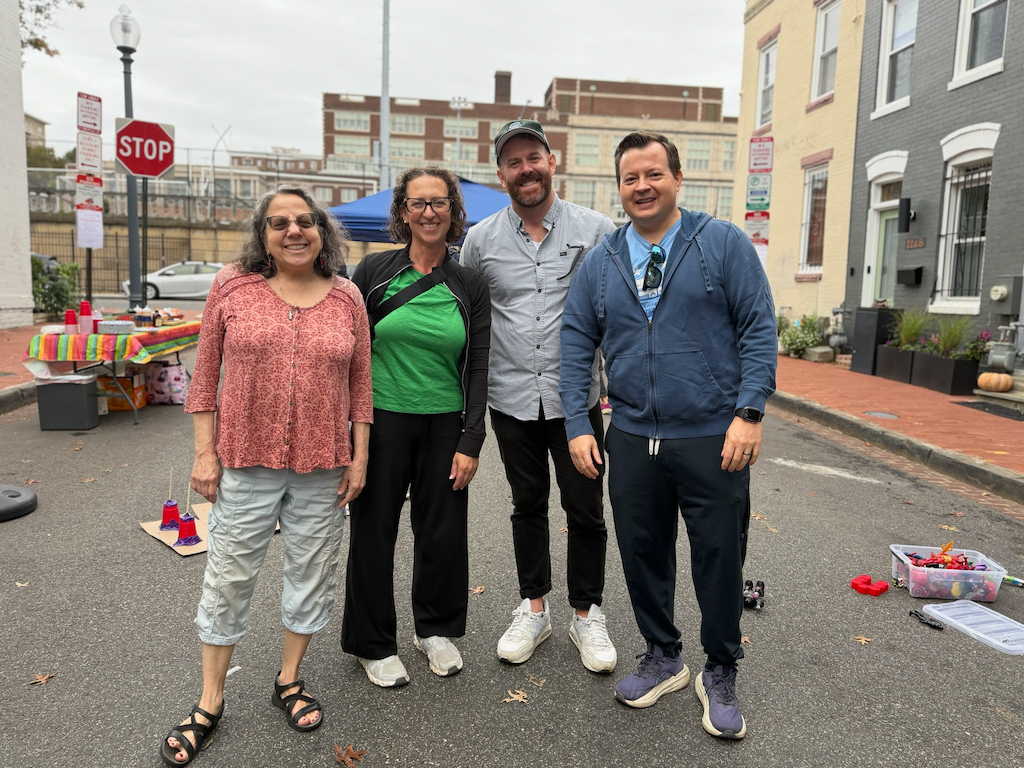Four people pose for a photo at the 12th Pl Block Party