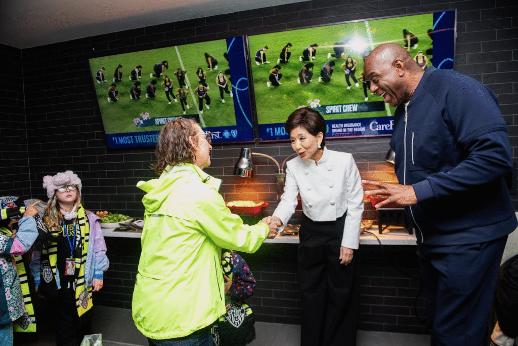 Councilmember Brianne Nadeau shaking hands with Michele Kang at a Washington Spirit match at Audi Field
