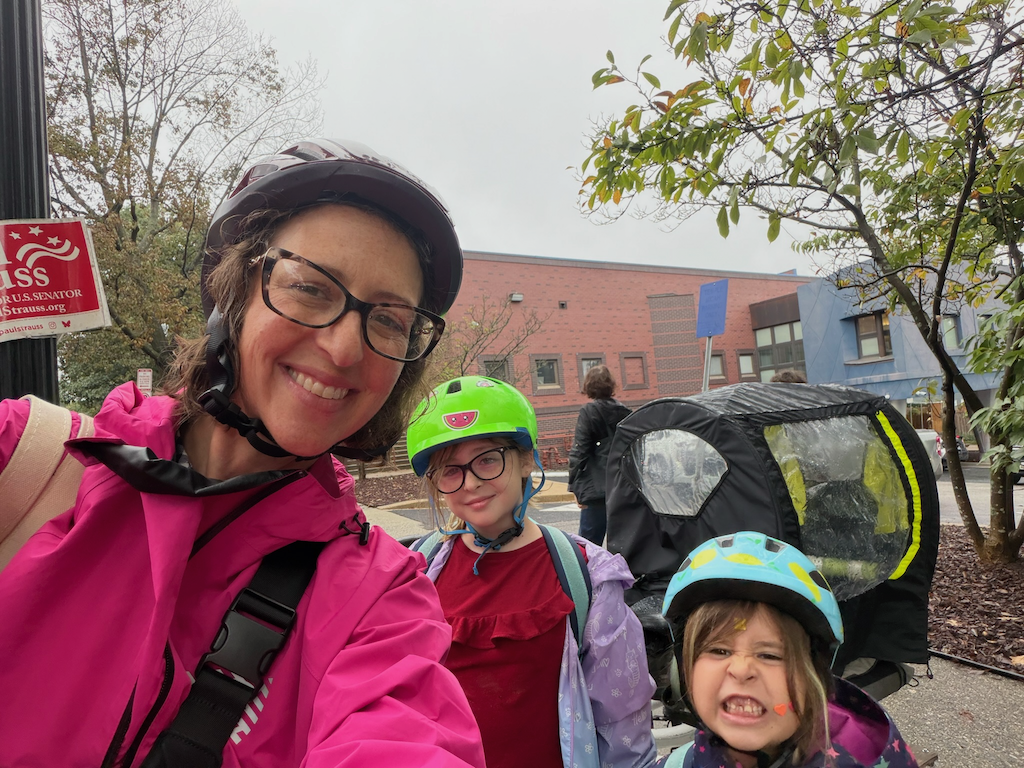 Councilmember Nadeau poses for a selfie with her two daughters and her bike
